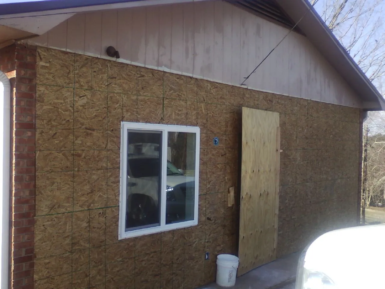 OSB sheathing on a garage addition wall before siding in Lonedell