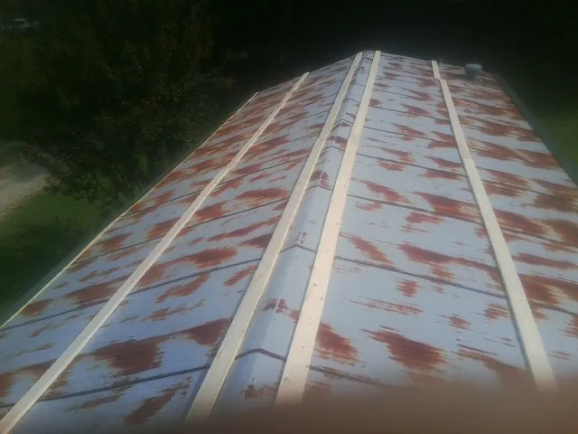 Rusted metal roof panels with new wood purlins before replacement — Storm Damage Roof Repair in Lonedell by Roofing Brothers